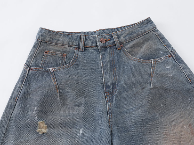 Close-up of the front waistband and pockets with contrast stitching and button closure