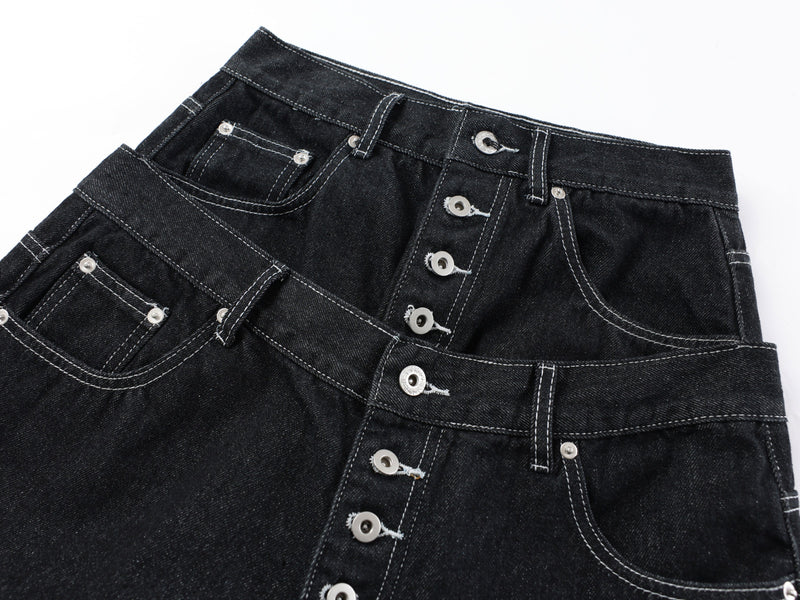 Close-up of the front waist and button fly on black denim pants