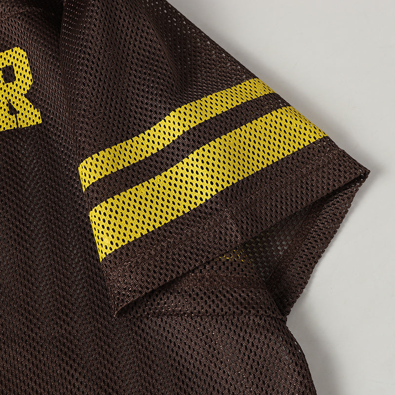 Close-up of a brown retro football mesh jersey sleeve with bold yellow striped trim and athletic streetwear styling