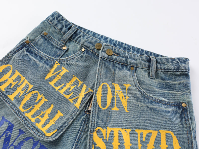 Close-up of the waistband and front top section of light blue graphic denim pants