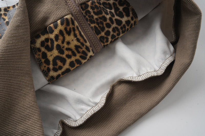 Inside view of leopard print hoodie hem with white lining and zipper