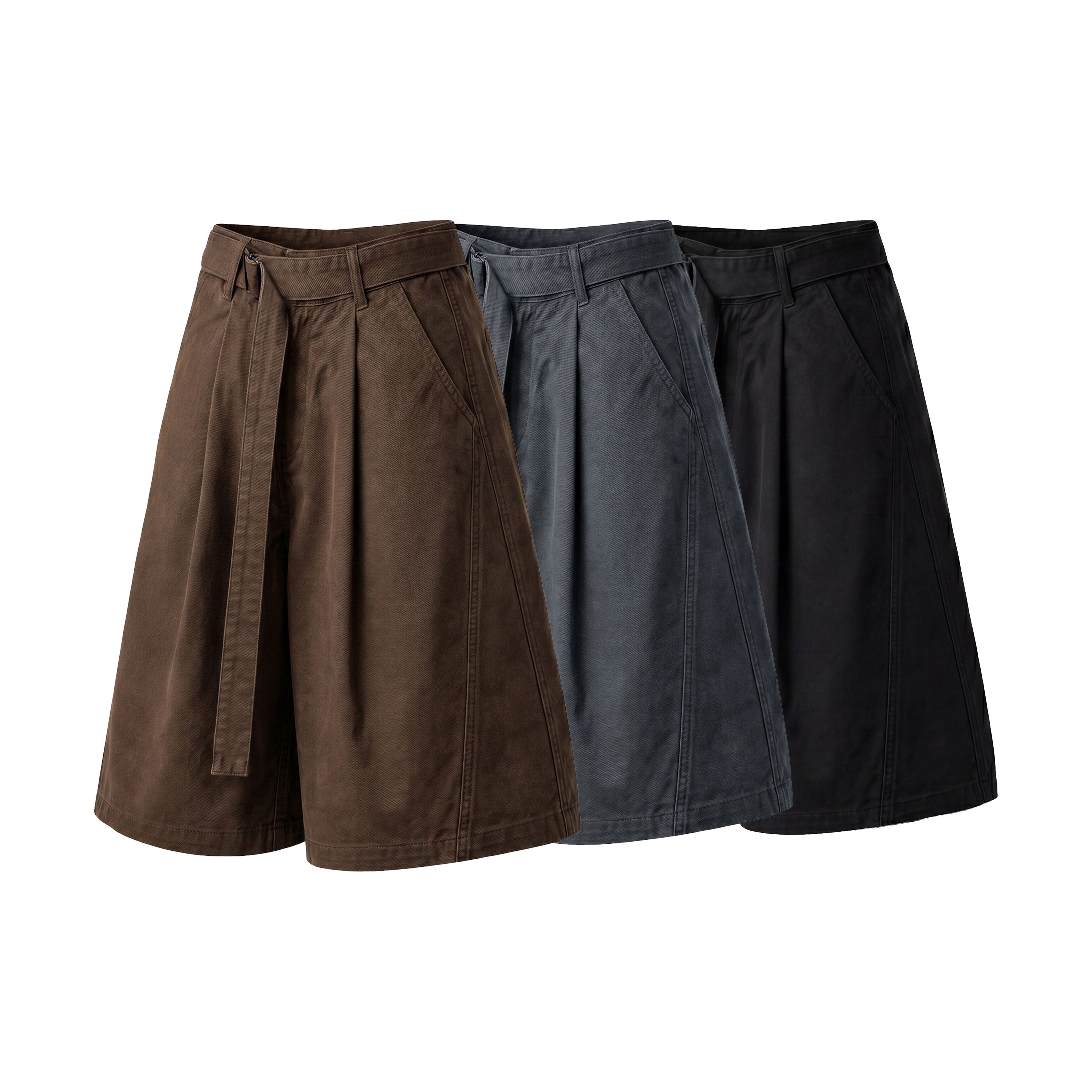 Three Omirad belted wide-leg pleated shorts displayed side by side in brown, slate grey, and black vintage washed cotton