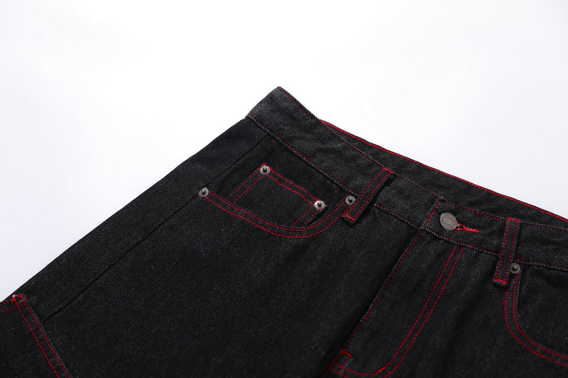 Close-up of front left waistband and pocket on black cargo denim pants