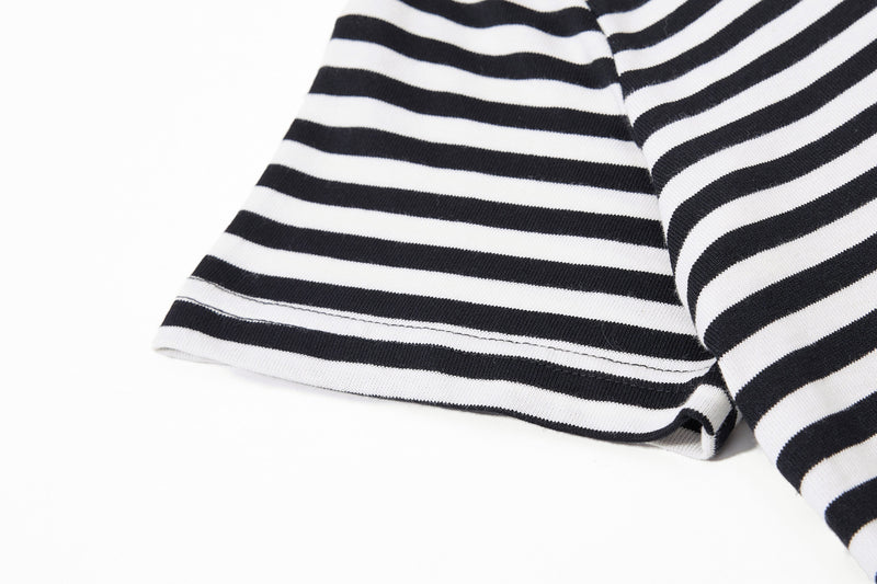 Black and white striped tee sleeve close-up with ribbed knit fabric and subtle stitched hem detail