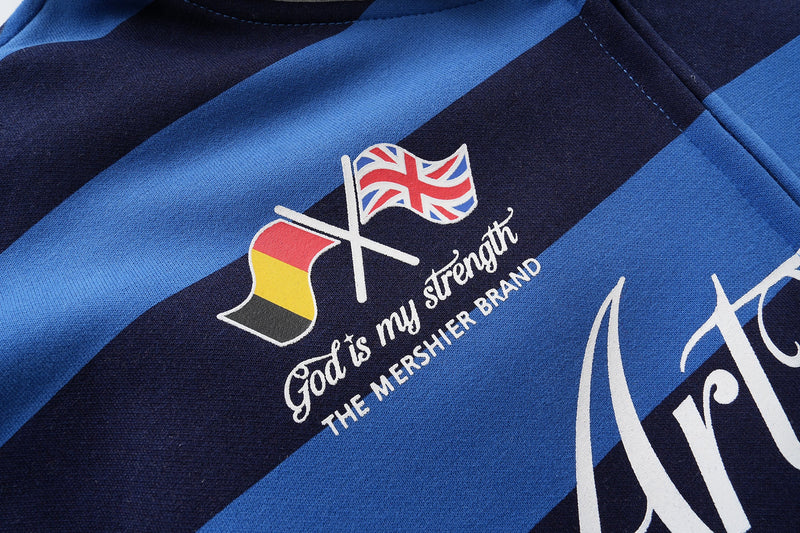 Close-up of small flag graphic and text print on blue and black striped hoodie