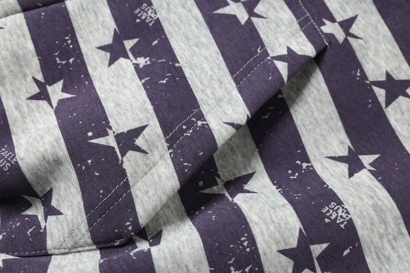 Close-up of the kangaroo pocket on a purple and gray striped star print hoodie