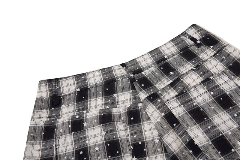 Top front waistband of black and white plaid cargo shorts with star print