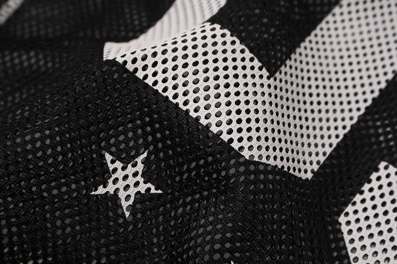 Close-up of black and white mesh jersey fabric with star pattern detail on a GlfsMade streetwear athletic tee