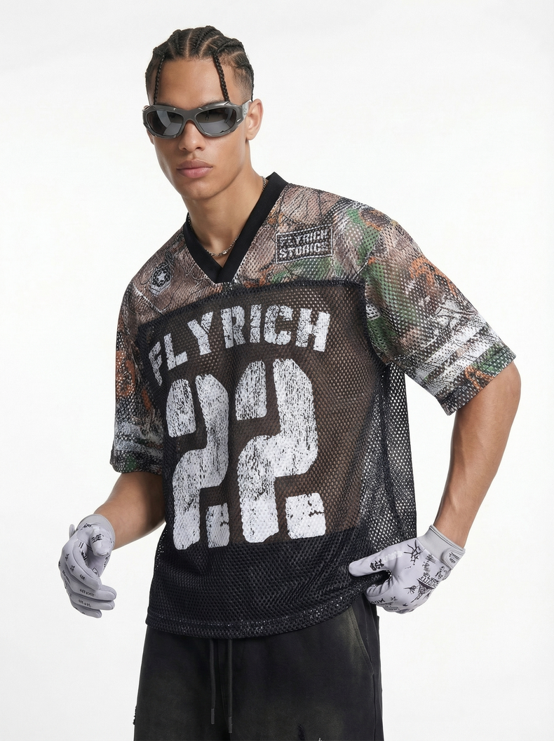 Model wearing a black camo mesh jersey T-shirt with Fly Rich 22 graphic, sunglasses, and gloves