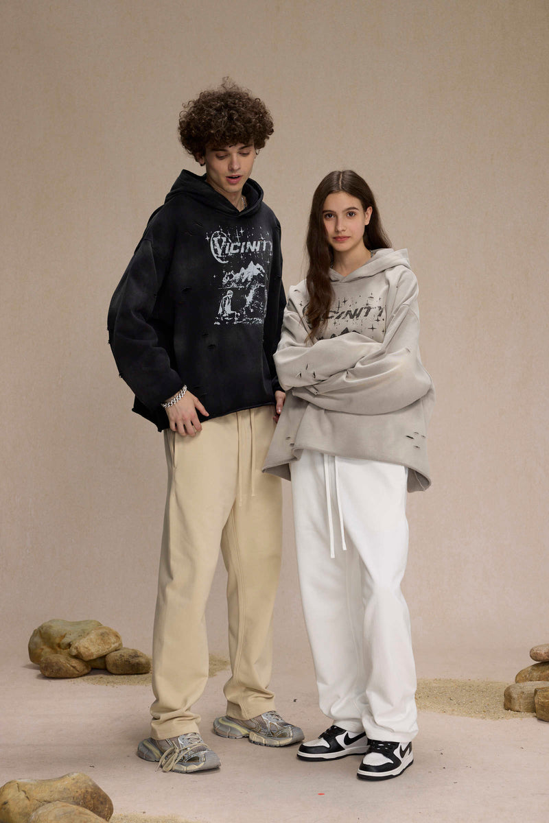 Two models wearing black and gray distressed Vicinity hoodies, side-by-side view