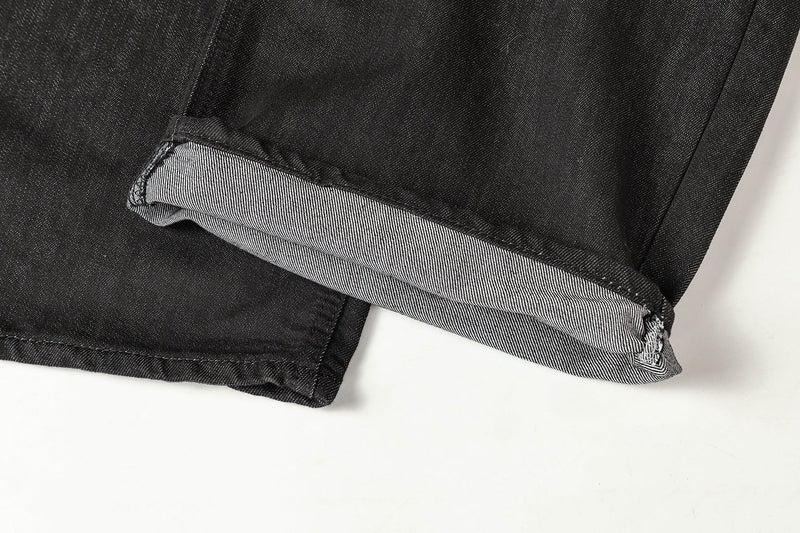 Cuffed hem close-up showing black denim exterior and striped inner cuff