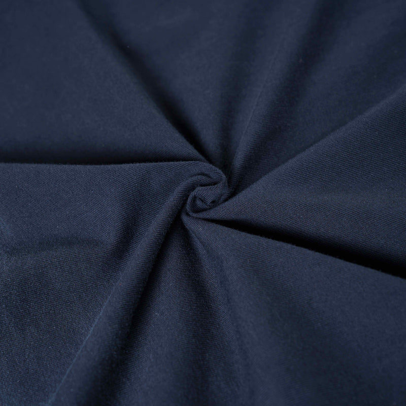 Close-up of navy blue distressed cotton tee fabric with soft vintage wash texture and gathered folds