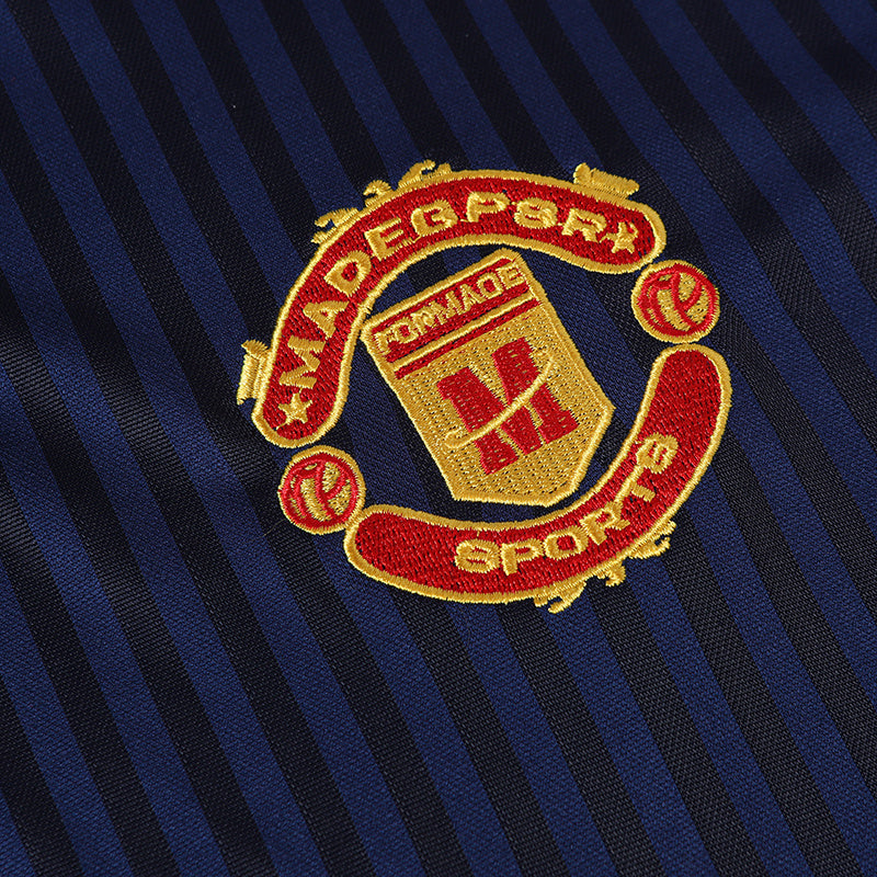 Navy striped sports club polo jersey with embroidered red and gold football-style crest on chest