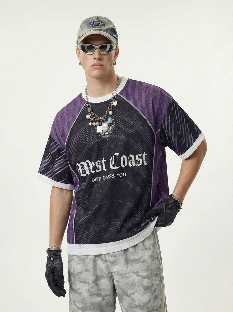 Model wearing a purple and black mesh soccer jersey with West Coast graphic, white trim, and gothic streetwear styling