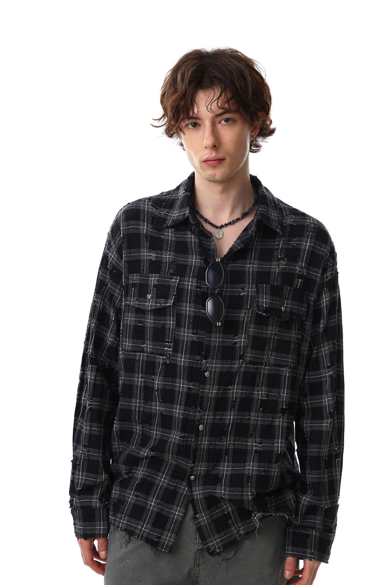 Model wearing black distressed plaid flannel overshirt with chest pockets