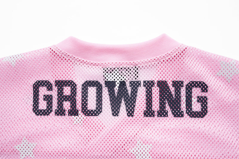 Pink mesh jersey with bold GROWING star print and ribbed crew neck, featuring an oversized varsity-style front graphic