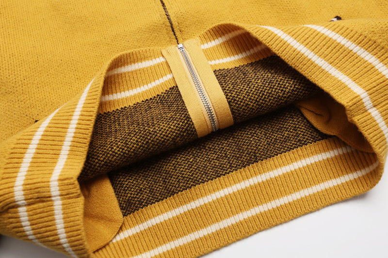 Close-up of jacket hem, zipper, and striped ribbed knit interior