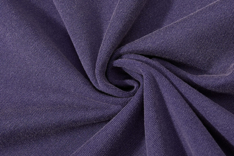 Close-up of purple washed knit tee fabric with soft vintage texture and draped folds