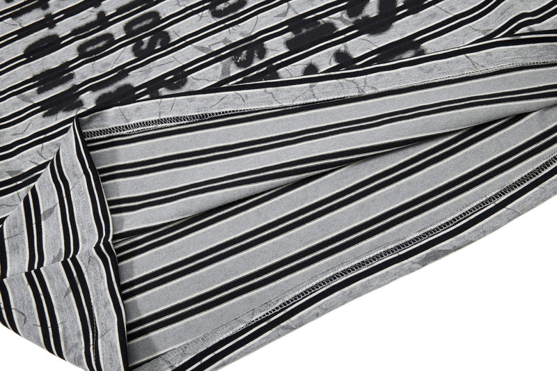 Black and gray striped streetwear T-shirt fabric with graffiti-style print and folded hem detail