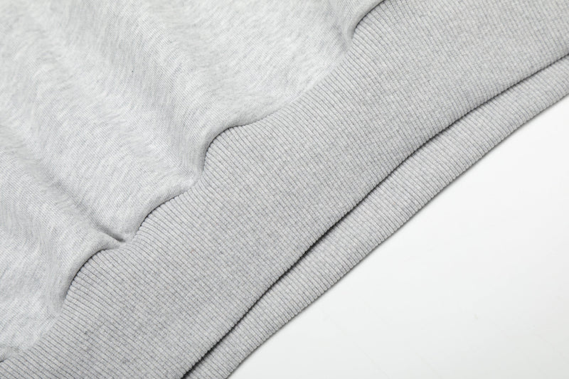 Close-up of light gray hoodie ribbed hem and sweatshirt fabric texture