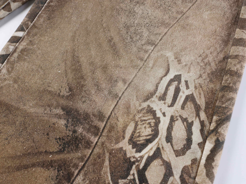 Close-up of beige and brown animal print fabric on the jeans leg