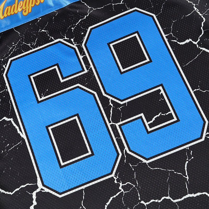 Close-up of a black mesh street football jersey with blue varsity number 69 and cracked flame-style print