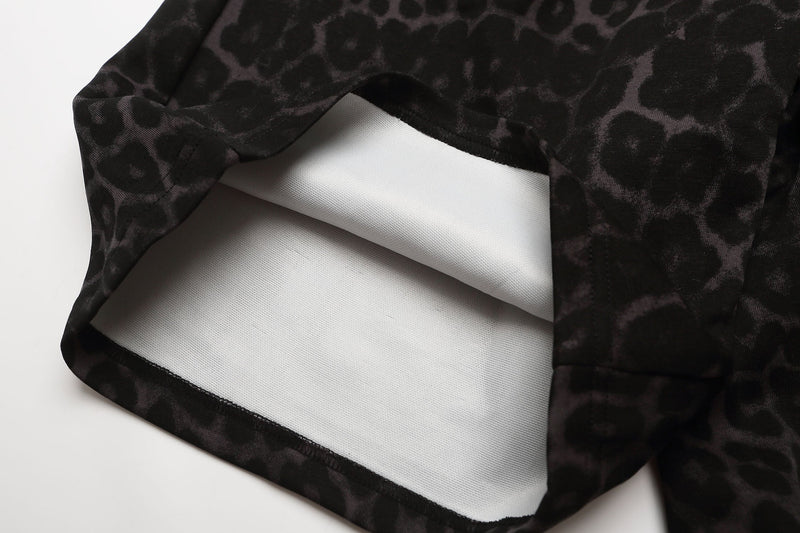 Close-up of black leopard print shorts hem showing white inner lining