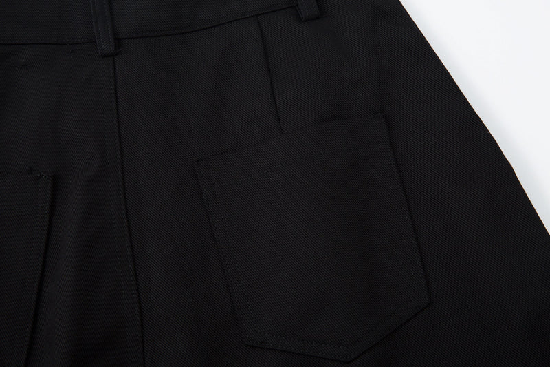 Close-up of back pocket stitching and panel seams on black pants
