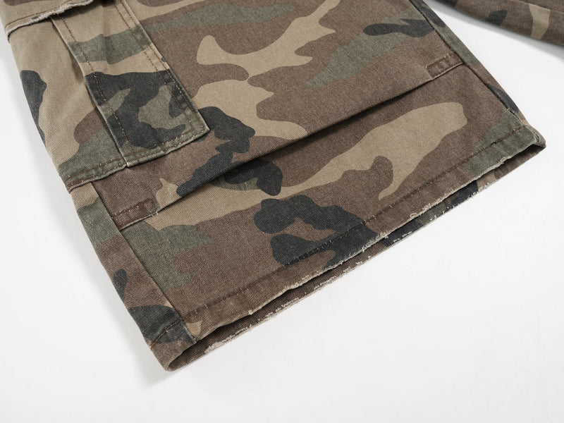 Hem of camouflage cargo shorts with cargo pocket seam and folded leg edge