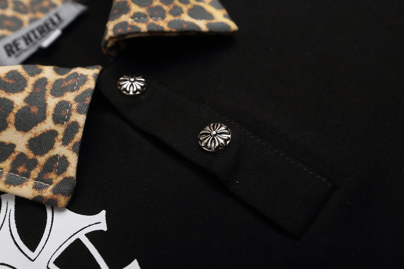 Black polo shirt with leopard-print collar and cuffs, silver gothic cross buttons, and bold Y2K streetwear details
