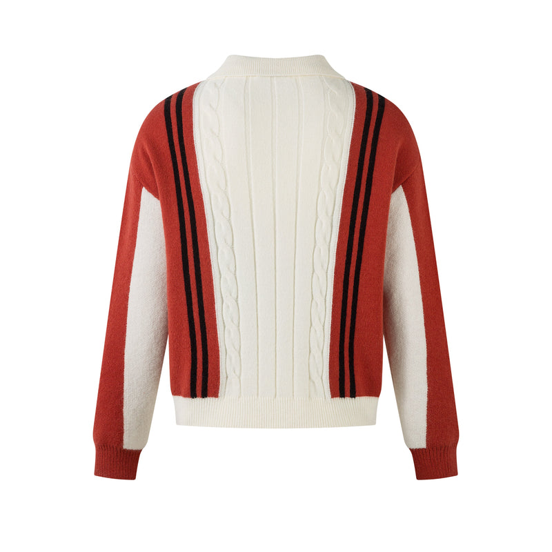Back view of cream cable-knit zip jacket with red sleeves and black stripe panels