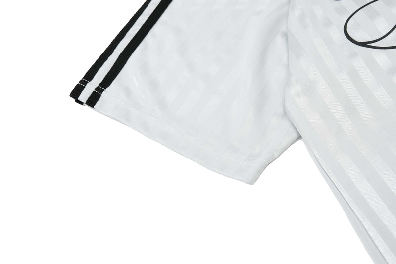 White retro football jersey with black script logo and double stripe sleeve detail
