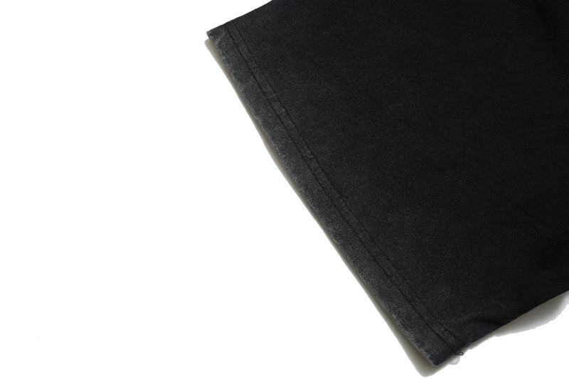 Black vintage washed graphic tee sleeve with stitched hem on a clean white background