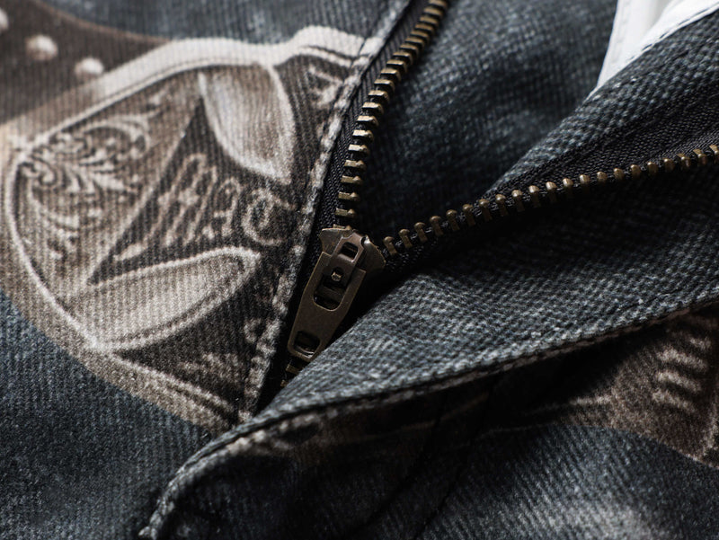 Close-up of zipper and butterfly graphic print on washed black denim jeans