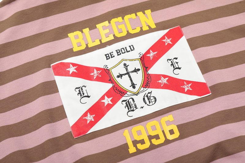 Close-up of back patch with cross graphic and red diagonal stripes on striped hoodie