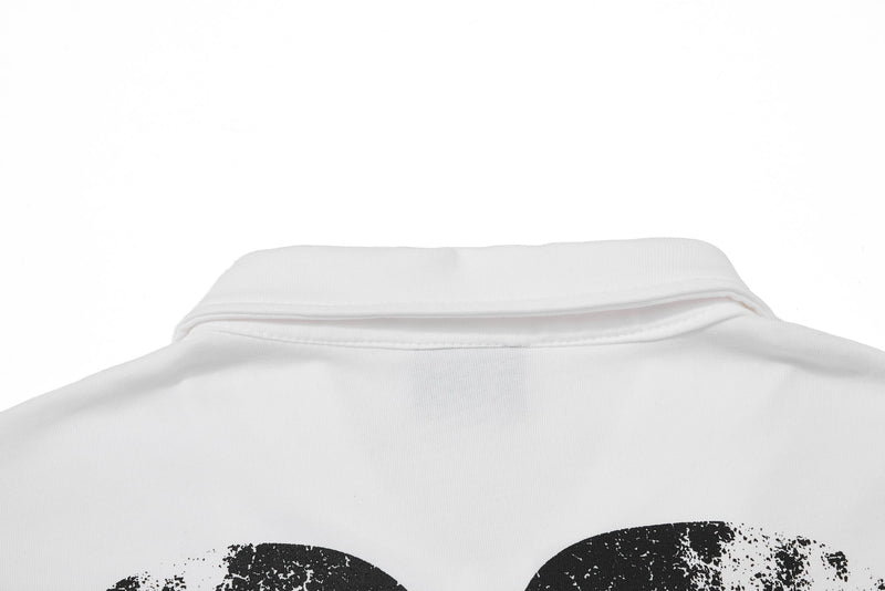 White streetwear polo tee with folded collar and bold black graphic print on the chest