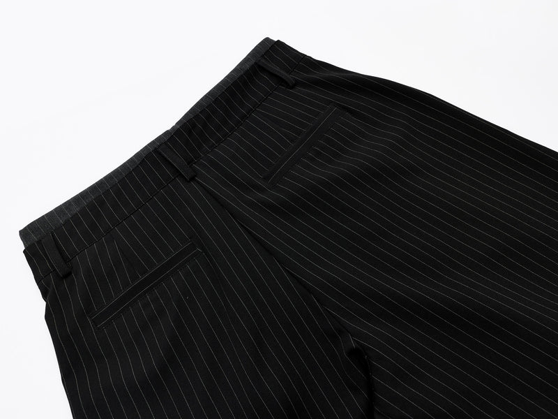 Close-up of back waistband and pocket detail on black pinstripe shorts