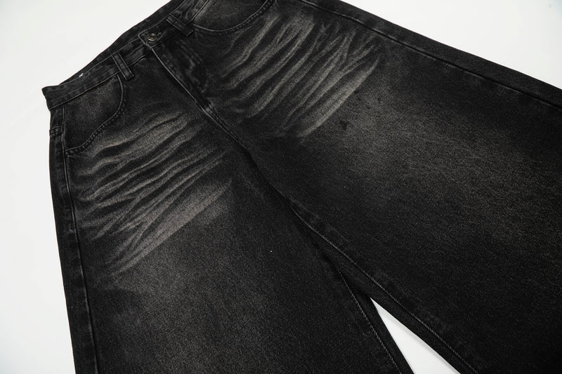 Black jeans upper leg and front pocket area with whisker wash
