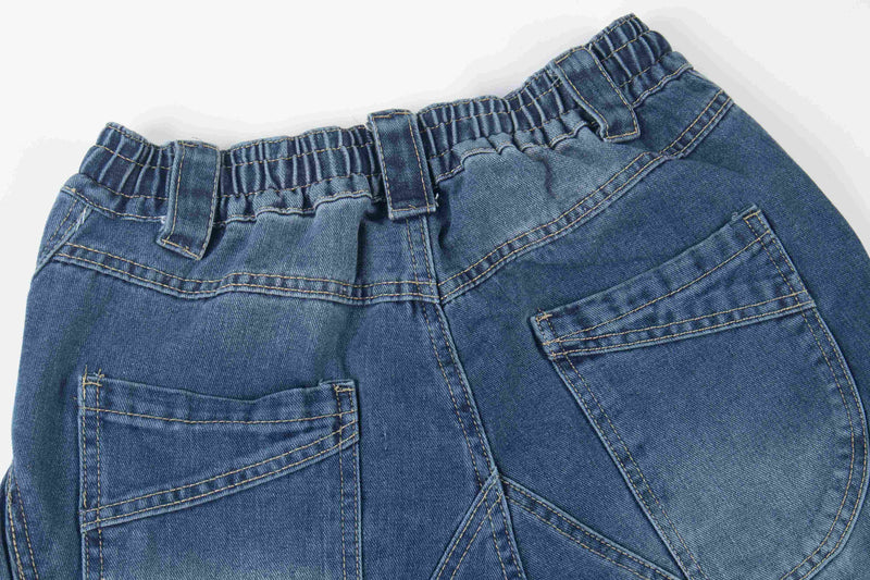Close-up of blue denim back pockets and gathered waistband stitching