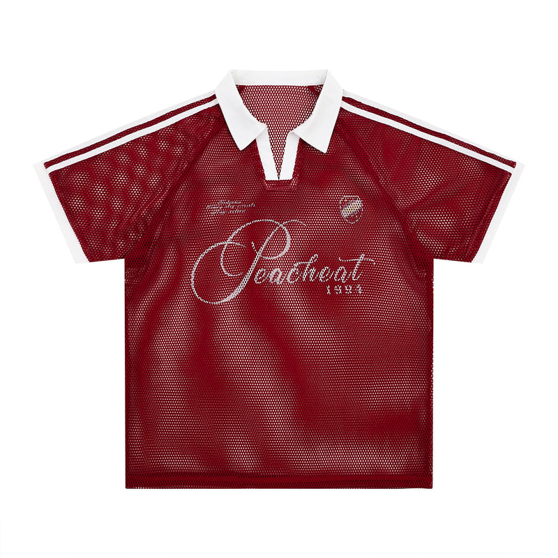 Red vintage mesh polo tee with white collar, striped shoulders, and retro script graphic on the chest