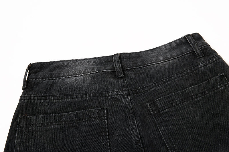 Back waistband of black denim jeans with belt loops and pocket tops