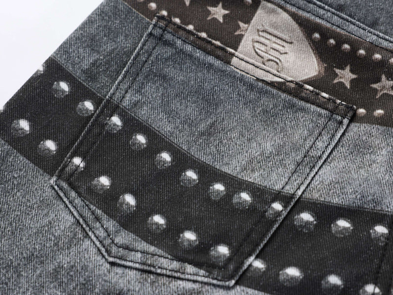 Close-up of back pocket on washed black jeans with star and stud print detail