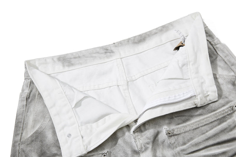 Inside waistband view of light gray jeans with zipper and snap closure