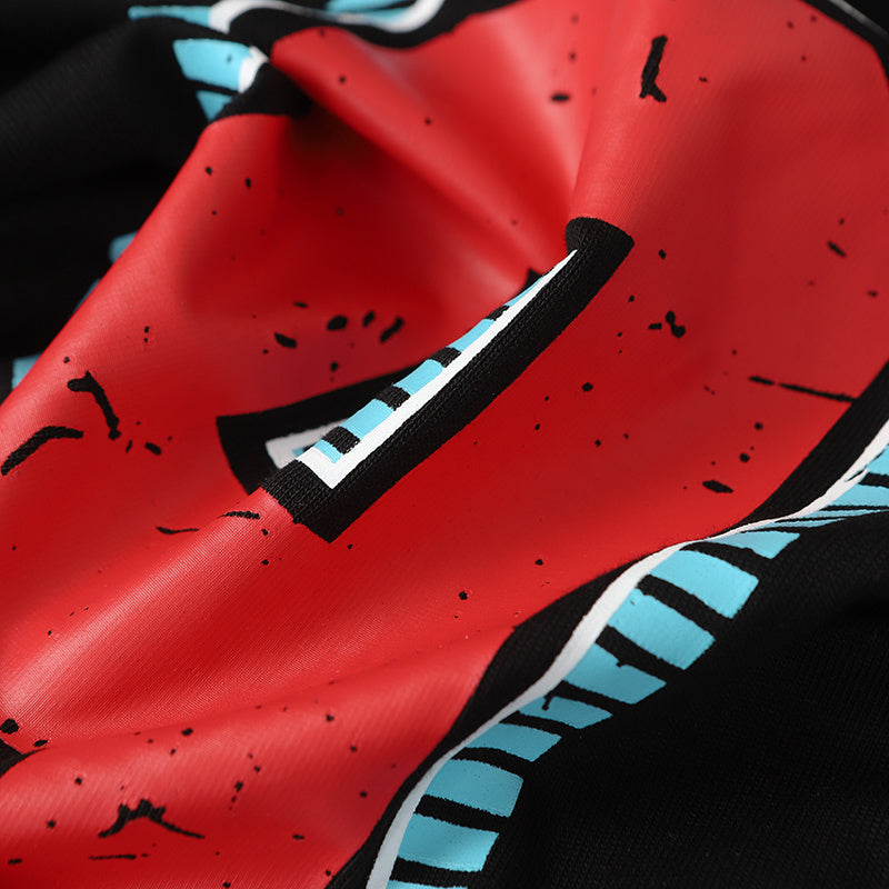 Close-up of a red racing graphic cotton T-shirt with black speckled print and blue striped accents, featuring number 9 details
