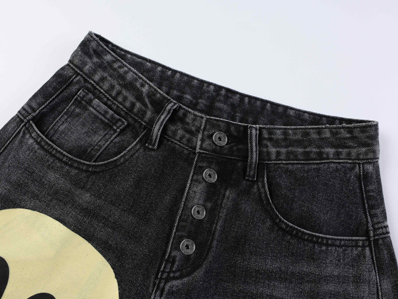 Close-up of black denim waistband and front pocket details