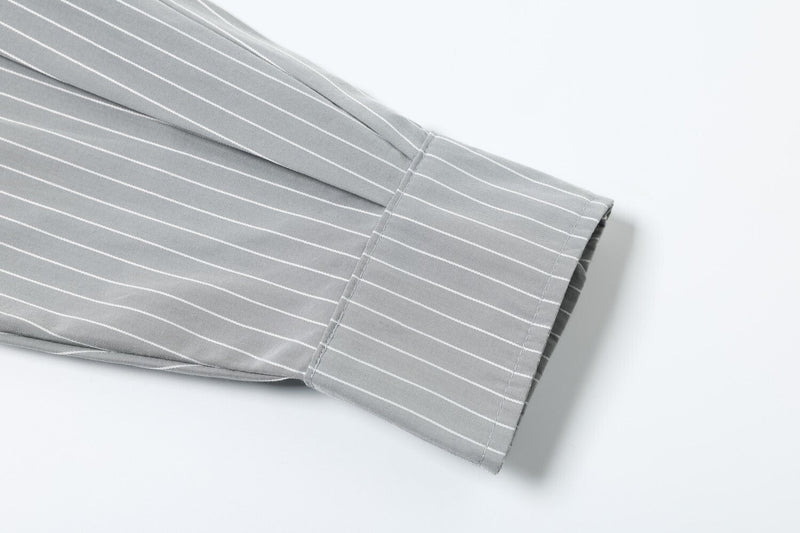 Close-up of striped sleeve cuff and folded hem on the layered long sleeve tee