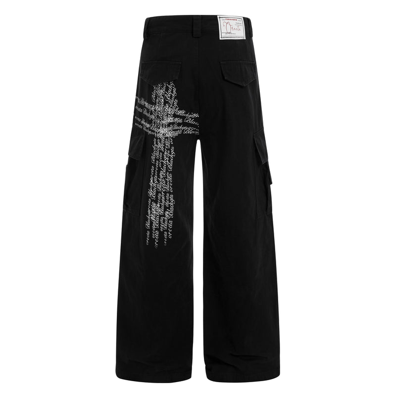 Back view of black cargo pants with white cross script graphic on the right leg