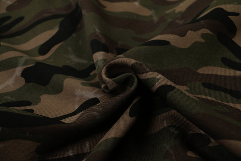 Close-up of camouflage hoodie fabric gathered in soft folds