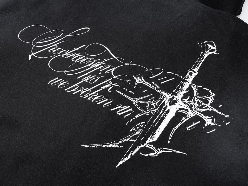 Close-up of black hoodie back print with script lettering and cross graphic