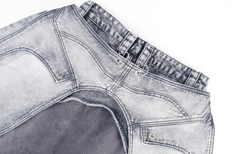 Close-up of side waistband with ring hardware, pocket flap, and mesh lining
